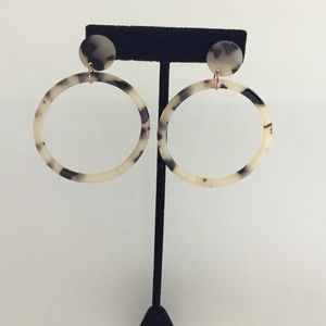 Resin tortious shell hoop earrings .